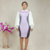 a model standing in lilac collared illusion sheath dress by Ria Kosher