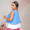 fair model wearing tri-coloured buttoned chiffon ruffle top by Ria Kosher - back view